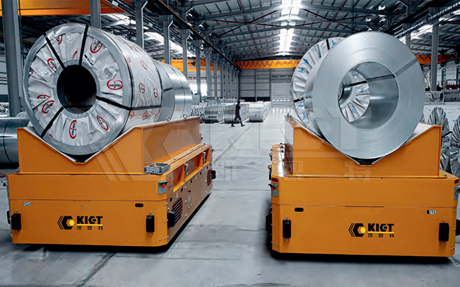 Intelligent heavy duty transfer vehicles are used for the transportation of steel coils, steel pipes and other materials in workshops of steel mills